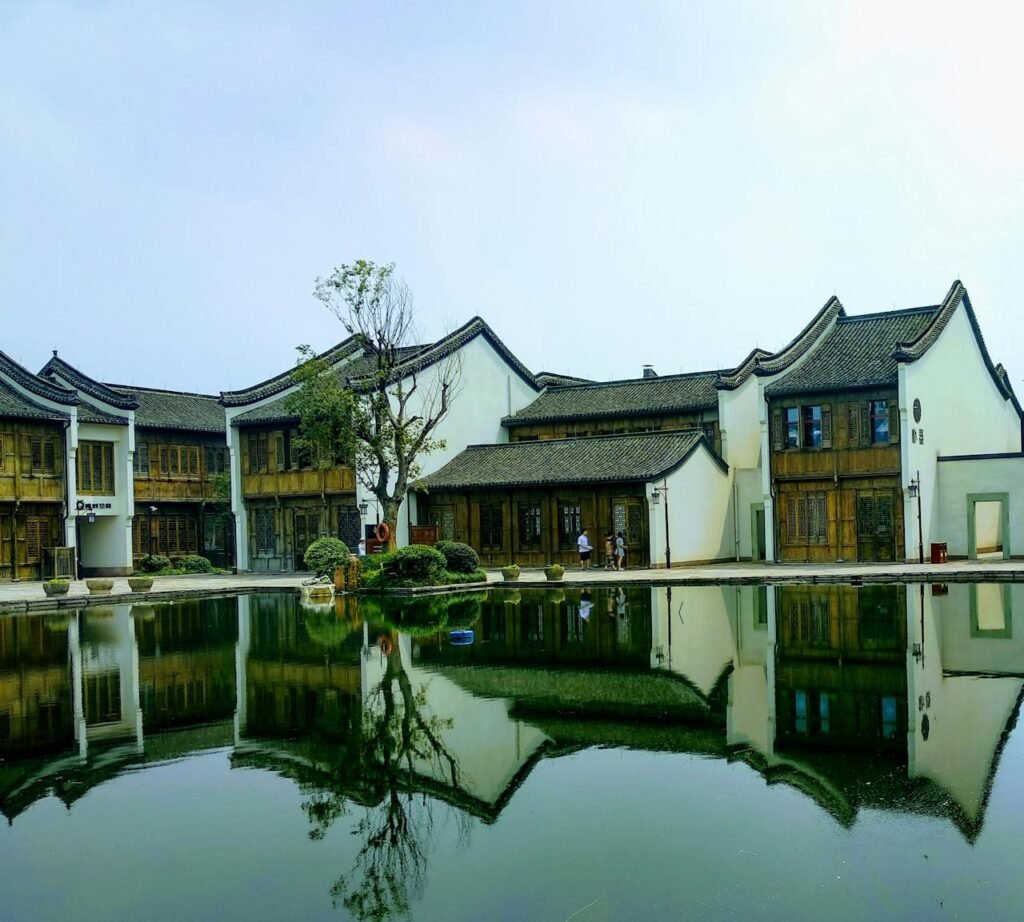 Brown and White Concrete House Beside Body of Water